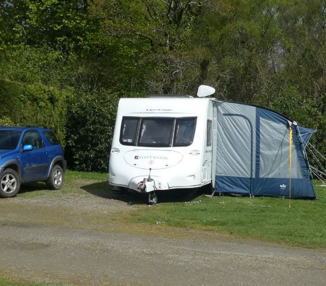 caravan and blue family car