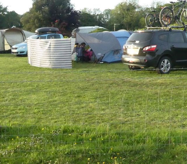 campsite and car park next to tents